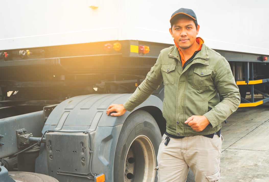 Portrait of truck driver with semi truck trailer